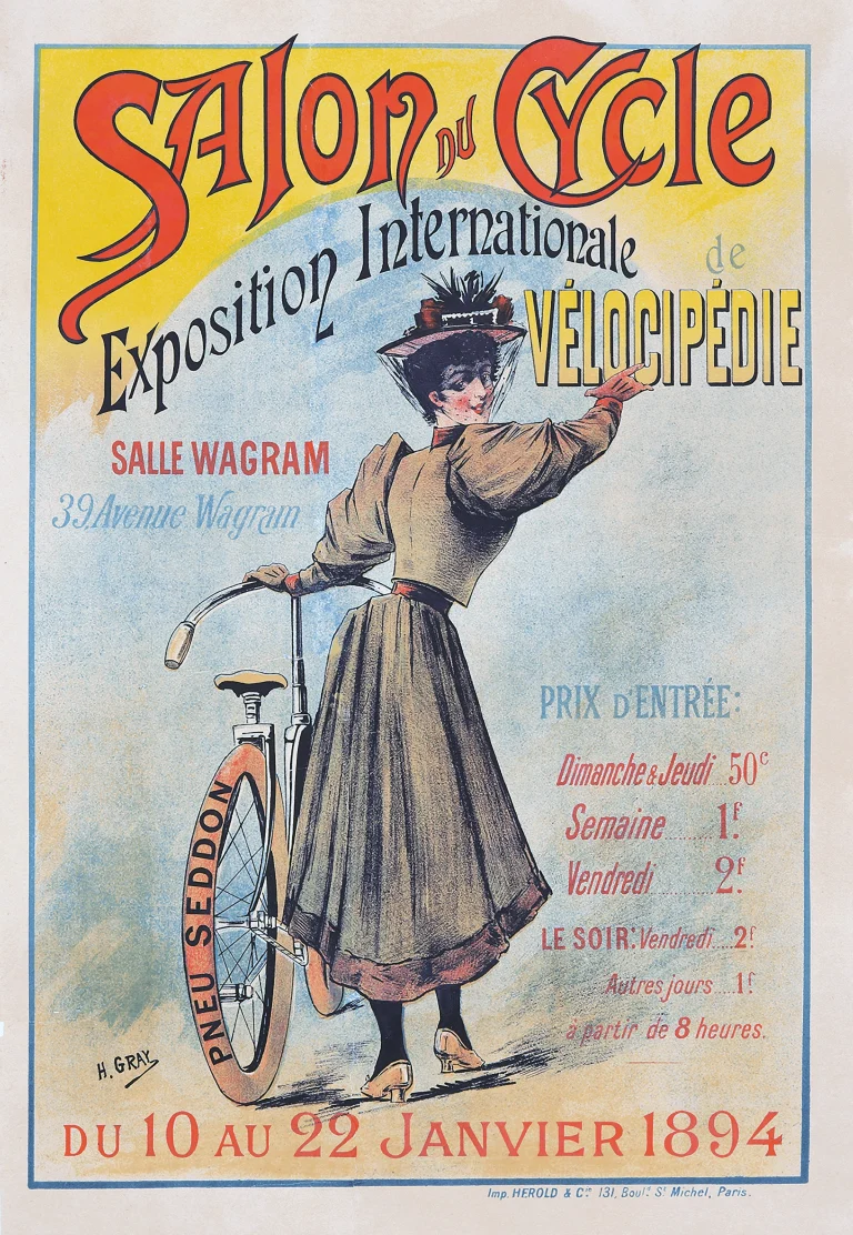 Color lithograph poster by H. Gray for the 1894 Salon du Cycle at the Salle Wagram in Paris, showing a woman in a long skirt and feathered hat beside a bicycle shod with Seddon tires