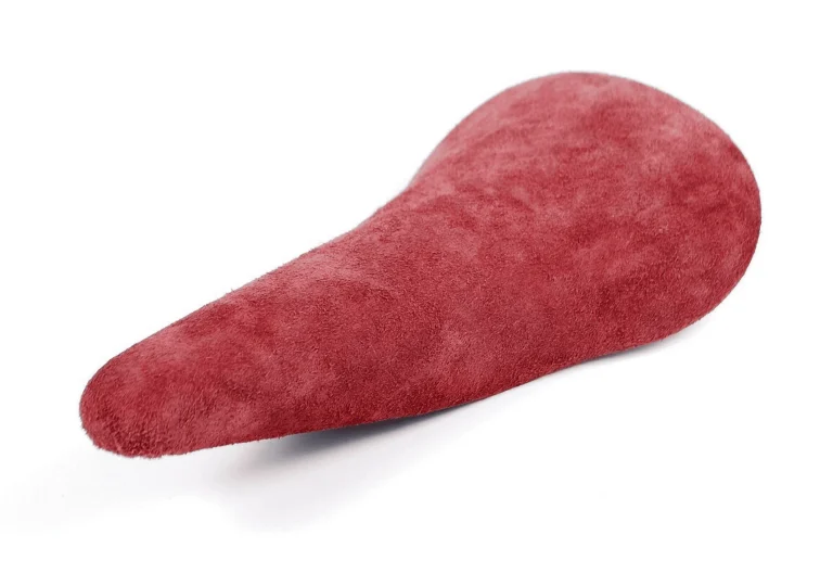 An Idéale TB 1 in deep red suede, unsprung and photographed against white to show its narrow nose and flared tail