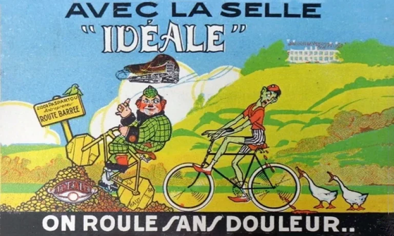 Color advertising card reading Avec la selle Idéale on roule sans douleur, contrasting a stout rider jolting over a barred road detour with a slim rider gliding past on smooth ground