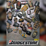 Bridgestone 1990 catalog cover photo showing metallic head badges and pins on a stone surface