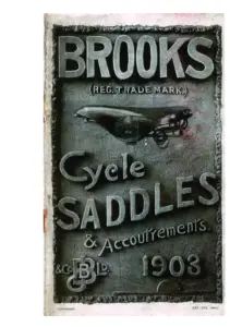 Catalog cover reproducing a photograph of a moulded plaque with a coarse pebbled ground. The word BROOKS stands in large relief capitals across the top with the words REG. TRADE MARK. beneath it. Below that a bicycle saddle is shown in side elevation, its cantle plate lettered B 10. The words Cycle SADDLES and Accoutrements run across the lower half in relief lettering, with an interlaced J B monogram flanked by the words and Co. and Ld. at the foot beside the year 1903. COPYRIGHT is printed at the lower left and ENT. STA. HALL. at the lower right.