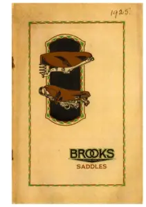 Buff card cover inside a green scalloped border, two saddles shown one above the other against a dark brown panel, with the Brooks wordmark and the word SADDLES beneath, and the year 1925 written by hand in ink at the top right.