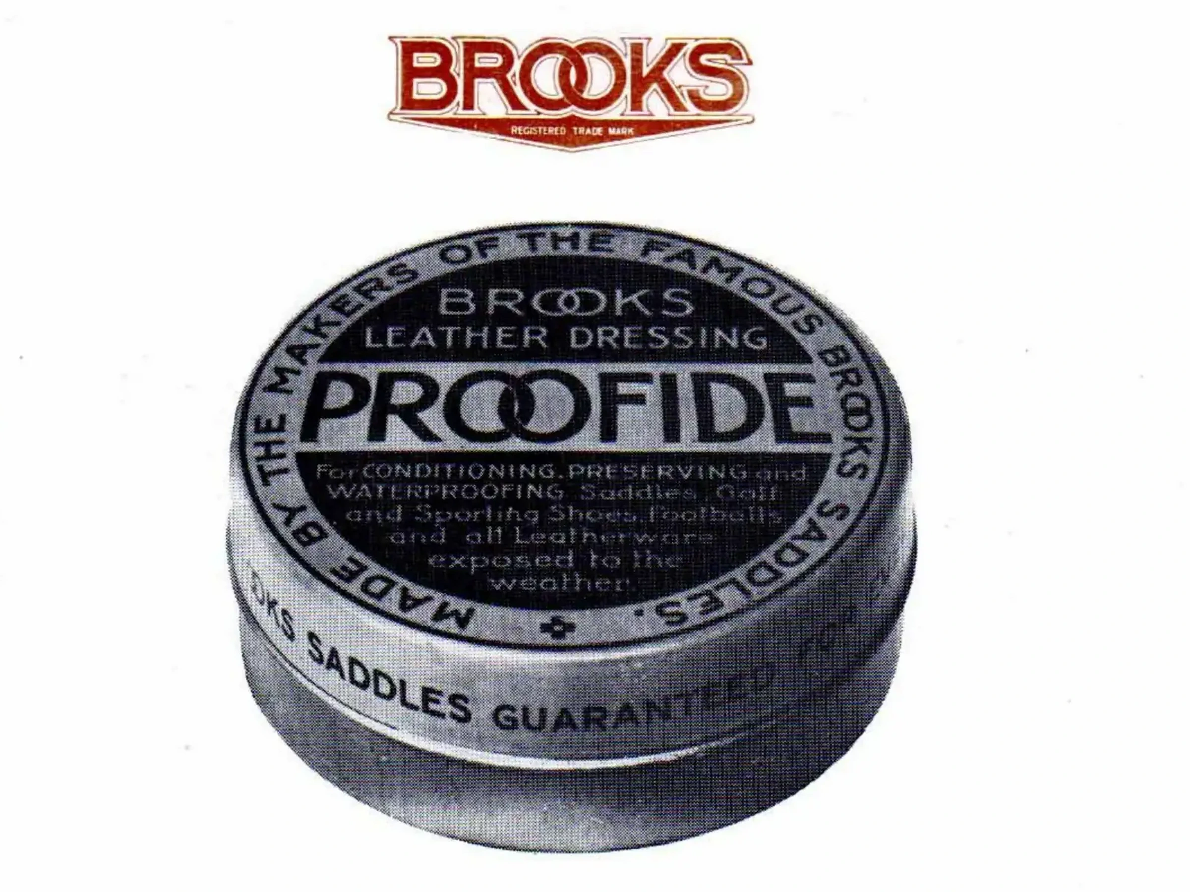 Photographic illustration of a circular tin seen from above at a slight angle, lettered BROOKS LEATHER DRESSING PROOFIDE across the center, MADE BY THE MAKERS OF THE FAMOUS BROOKS SADDLES around the lid and BROOKS SADDLES GUARANTEED around the rim, beneath the Brooks wordmark in red