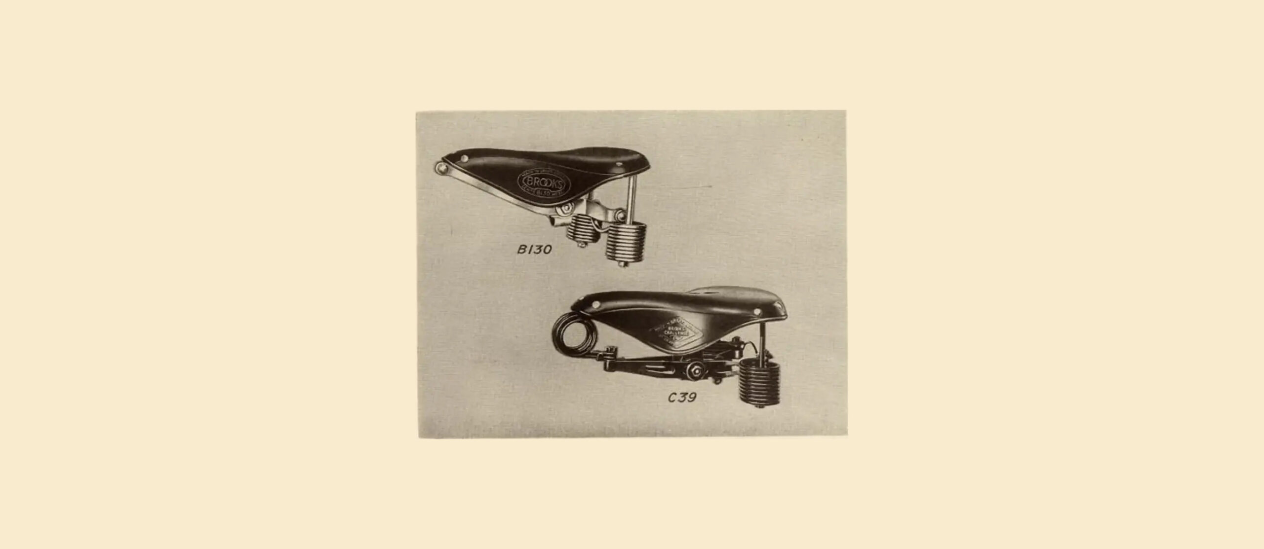Halftone catalog plate showing two sprung leather bicycle saddles in three-quarter view, the Brooks B.130 above and the Brooks Challenge C.39 below, each with a badge on the leather top and closely wound tension coil springs at the rear.
