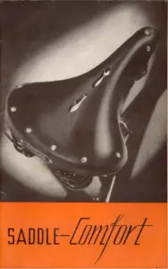Catalog cover showing a black leather sprung Brooks saddle lit from behind against a dark ground, with a broad orange band across the foot carrying the words SADDLE-Comfort.