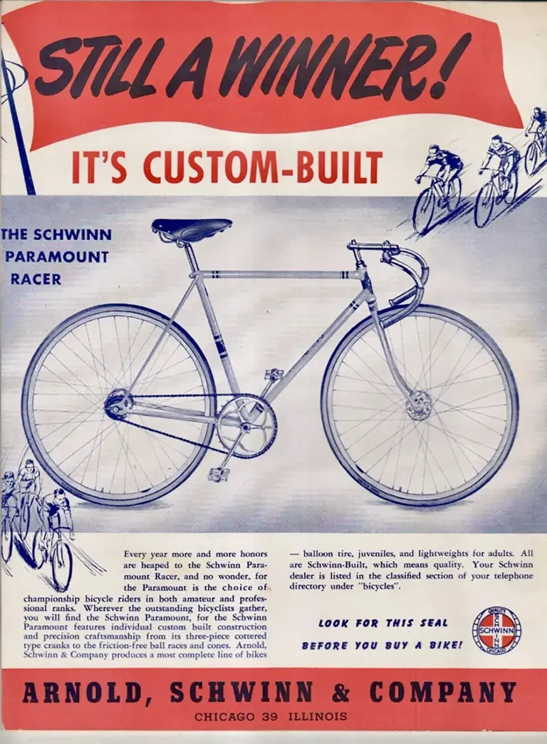 Blue-toned advertisement headed Still a Winner above the line It Is Custom-Built, showing a Schwinn Paramount Racer in profile with sketched groups of racing cyclists in the corners