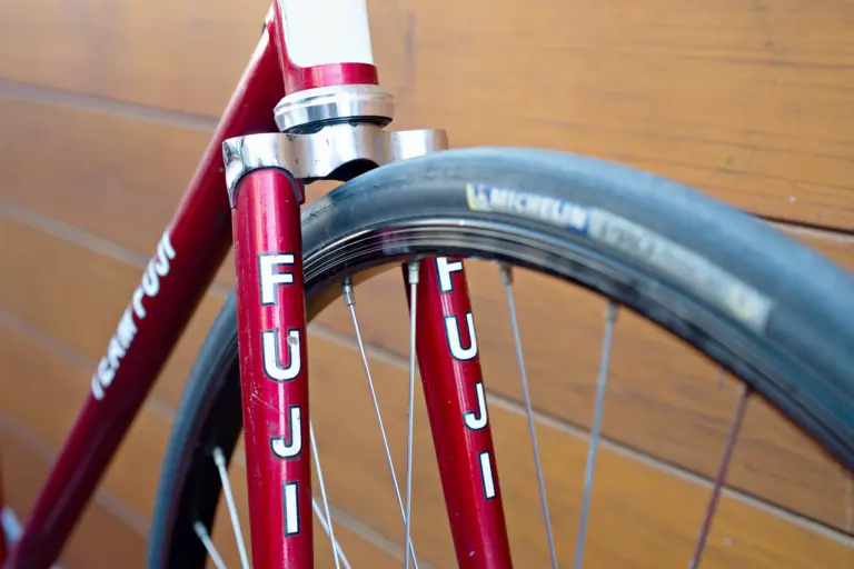 FUJI decals on both fork blades of the Team Fuji, alongside the Michelin Pro Race front tire and the Araya rim