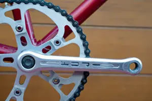 Sugino crank arm engraved FUJI on the Team Fuji, with the drilled chainring and its SUGINO CHAINWHEELS bolts