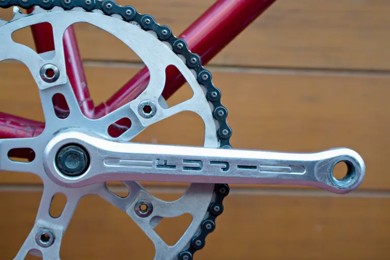 Sugino crank arm engraved FUJI on the Team Fuji, with the drilled chainring and its SUGINO CHAINWHEELS bolts