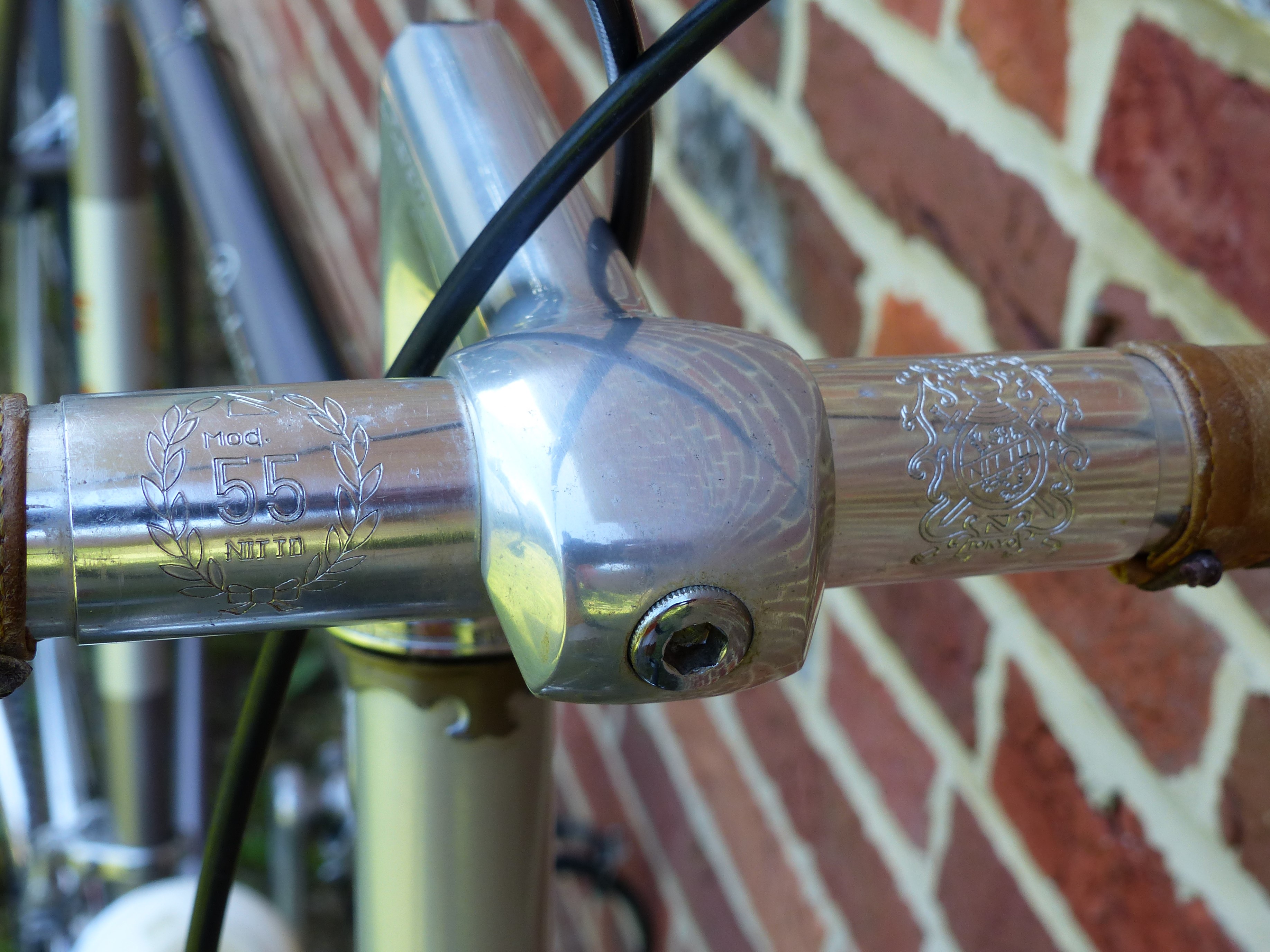 Polished aluminium Nitto Mod. 55 stem engraved with a laurel wreath, clamped to a handlebar carrying the Nitto crest