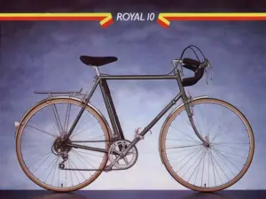 A Raleigh catalog page: a dark green ten-speed touring bicycle photographed square on from the drive side against a graduated blue-grey ground, fitted with front and rear carriers, taped drop bars and gum-wall tires, with ROYAL 10 set in a band across the head of the page between red and yellow chevrons.