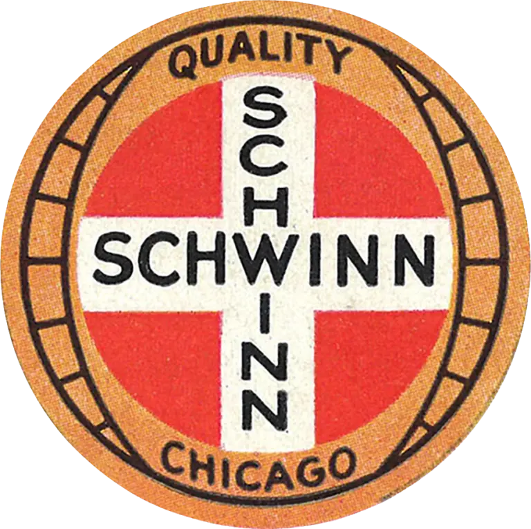 Circular Schwinn badge with a red field, a white cross lettered SCHWINN twice, and a tan outer ring reading QUALITY and CHICAGO