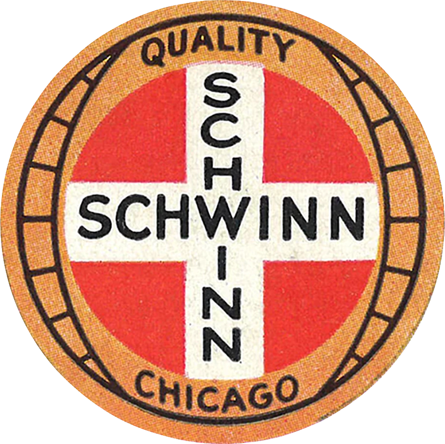 Circular Schwinn badge with a red field, a white cross lettered SCHWINN twice, and a tan outer ring reading QUALITY and CHICAGO