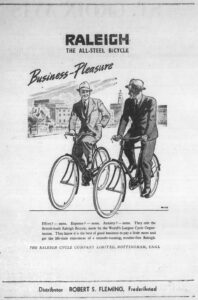 Near full-page newspaper advertisement headed RALEIGH, THE ALL-STEEL BICYCLE, with Business-Pleasure in sloping script above a wash drawing of two men in business suits and soft hats riding roadster bicycles side by side toward the viewer against a sketched city of civic buildings and a clock tower, four lines of body copy beginning Effort? none. Expense? none. Anxiety? none, the line THE RALEIGH CYCLE COMPANY LIMITED, NOTTINGHAM, ENGL beneath, and a foot panel reading Distributor ROBERT S. FLEMING, Frederiksted.