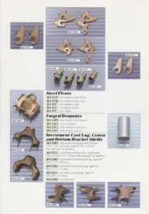 Page of studio photographs on blue grounds showing brake pivots, forged dropouts and investment cast lugs, crowns and bottom bracket shells, each labeled with a Ref code, beside three lists headed Steel Pivots, Forged Dropouts and Investment Cast Lug, Crown and Bottom Bracket Shells.