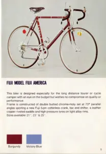Catalog page for the Fuji America, a burgundy touring bicycle with leather saddle and bar-end shifters, above a description and two color swatches labeled Burgundy and Victory Blue