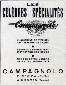 A framed trade-paper advertisement: "Les célèbres spécialités", the Campagnolo script across a ruled globe throwing out rays, three specialties separated by dots and "Campagnolo, Vicenza (Italie) & Cognin (Savoie)".