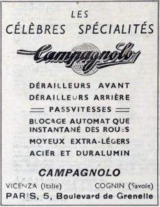 A framed trade-paper advertisement: "Les célèbres spécialités", the Campagnolo script over a ruled globe, front and rear derailleurs, the Passvitesses, the quick release and light hubs, with Vicenza, Cognin and "Paris, 5, Boulevard de Grenelle".