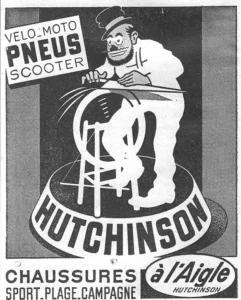 Hutchinson advertisement from L'Officiel du cycle, 6 July 1957, page 24: a bearded cartoon man in a small round brimmed hat and spectacles, drawn like a street knife grinder, presses a long blade against a spinning wheel on a wooden stand, with streaks flying from the wheel, the whole set on a round drum that carries the HUTCHINSON name in heavy capitals.