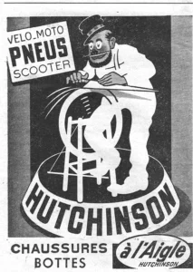 Hutchinson advertisement from L'Officiel du cycle, 21 December 1957, page 6: a bearded cartoon man with round staring eyes, in a peaked cap with a striped band and a white smock, drawn like a street knife grinder, presses a long blade against a spinning wheel on a wooden stand, with streaks flying from the wheel, the whole set on a round drum that carries the HUTCHINSON name in heavy capitals.