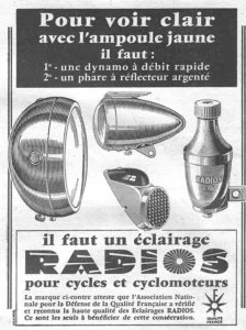 Radios advertisement from L'Officiel du cycle, 16 February 1957: a drawing of four lighting parts: a large round headlamp seen from the side with its glass rim at the right, a bullet-shaped headlamp with a visor and a mounting lug, a wedge-shaped rear lamp with a studded lens and a bottle dynamo with a knurled cap, a RADIOS label and a clamp bracket.