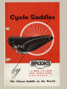 The cover side of the Brooks "Cycle Saddles" leaflet in three panels.