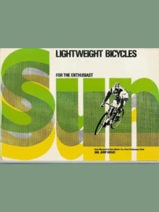 Front cover: the word "Sun" in giant green, yellow and gray halftone letters across the page, with a high-contrast black and white photograph of the racing cyclist Keith Mernickle riding over the "u" and "n".