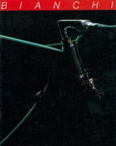 Front cover of the undated Bianchi catalog (after 1987): a close photograph of the front of a pale blue-green racing bicycle on a black ground, its eagle head badge, stem and handlebar under a red band carrying the name Bianchi in spaced capitals.