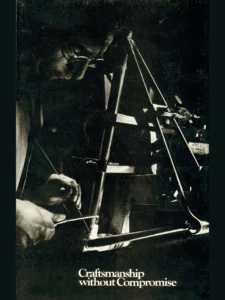The brochure's front cover: a dark photograph of a frame builder in glasses brazing a frame held in a jig, a torch in one hand and a brazing rod in the other.
