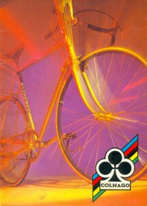 Front cover: a close photograph of a road bicycle lit in gold and orange, with the Colnago clover emblem and COLNAGO name.