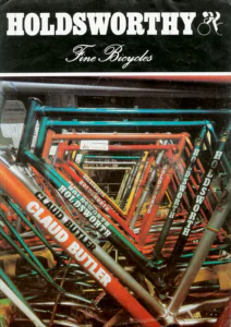 Front cover: a close photograph of a stack of bare frames in blue, orange, yellow and silver, with Holdsworth, Claud Butler and Professional transfers, under the Holdsworthy name and its cyclist logo.
