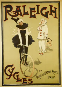 Raleigh poster of about 1895: a young woman dressed as Pierrette in a black tutu, ruff and pointed hat rides straight toward the viewer, while a white-clad Pierrot with a mandolin watches, between RALEIGH at the top and CYCLES, 27 AVENUE DE LA GRANDE ARMÉE, PARIS at the foot.
