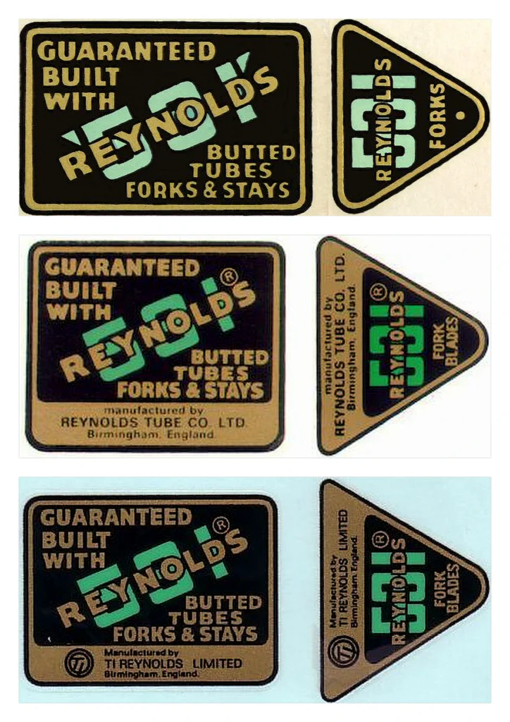 Three Reynolds 531 frame transfers stacked one above another, each beside its triangular fork transfer, all green, gold and black and reading GUARANTEED BUILT WITH REYNOLDS 531 BUTTED TUBES FORKS & STAYS: the top one with no maker’s line, the middle one with a gold box reading manufactured by Reynolds Tube Co. Ltd., Birmingham, England, and the bottom one with a TI roundel and Manufactured by TI Reynolds Limited, Birmingham, England.